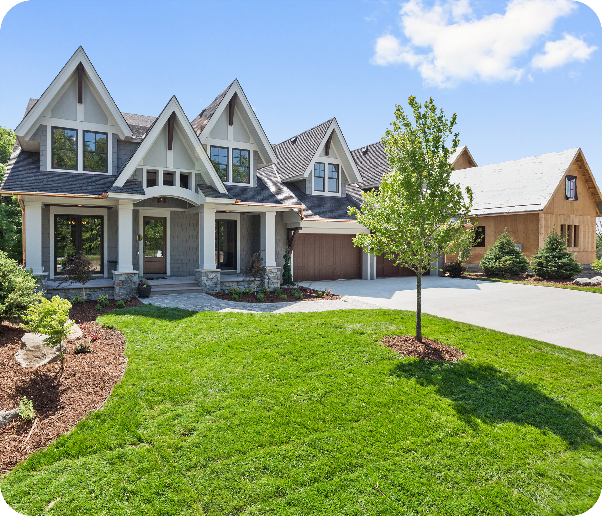 A large house with a lush green lawn in front of it