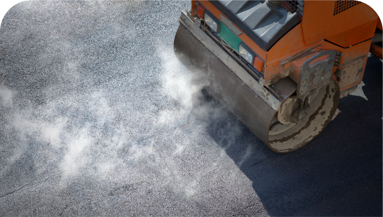 A roller is rolling asphalt on a road.