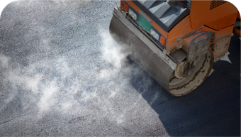A roller is rolling asphalt on a road.