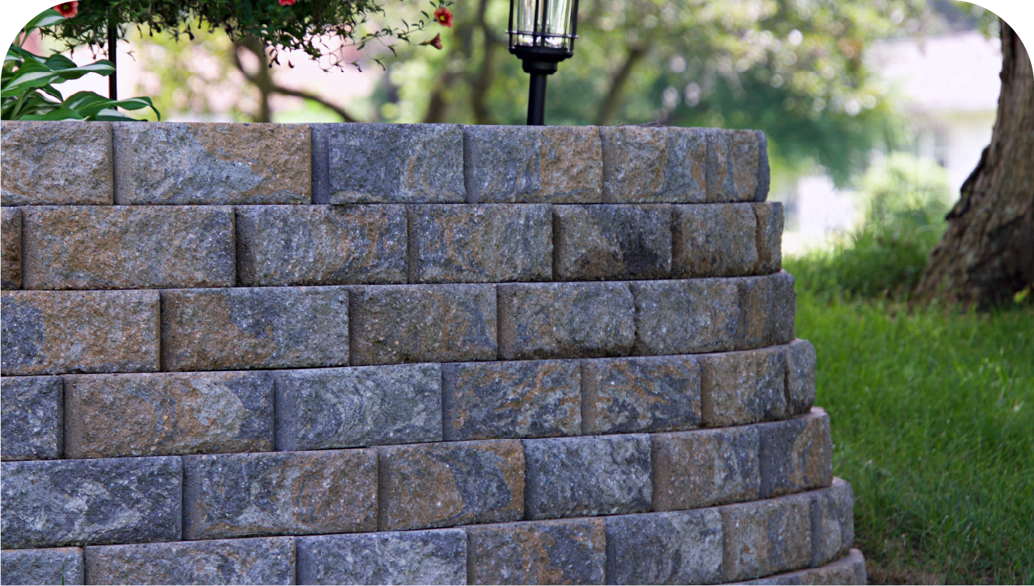 A brick wall with a lamp on top of it