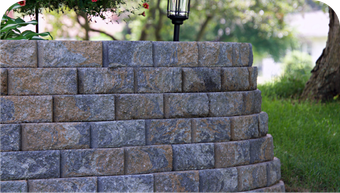 A brick wall with a lamp on top of it