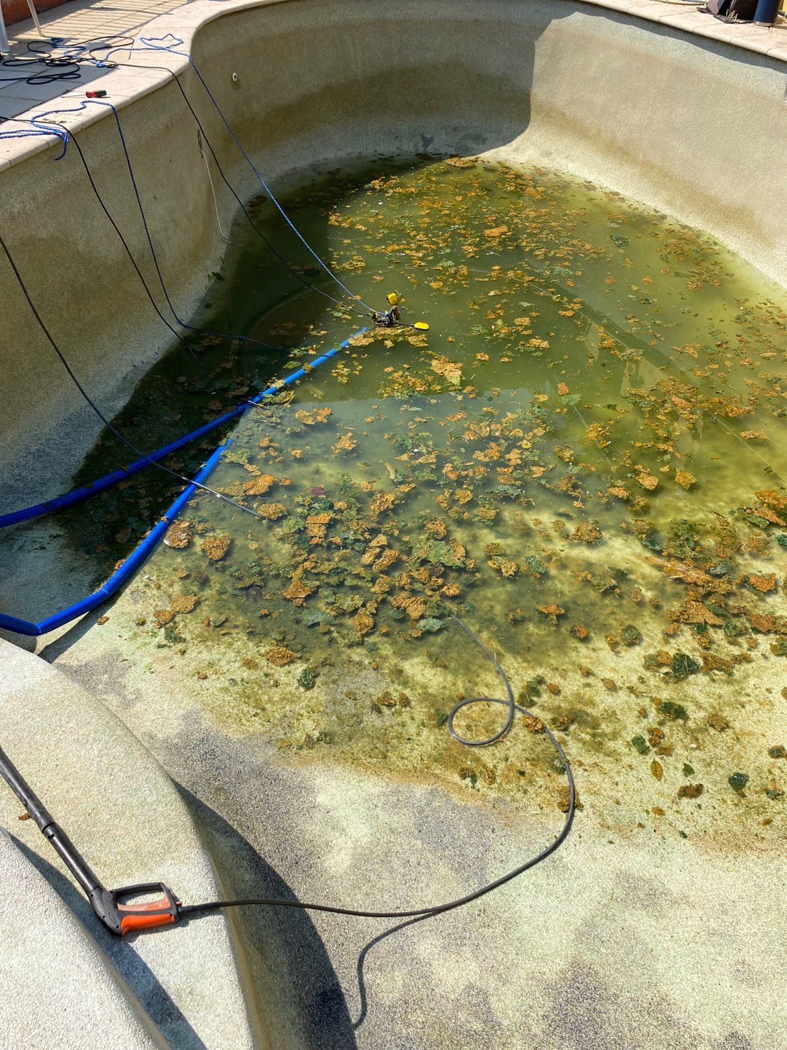 A Man Wearing a Mask is Working on a Swimming Pool — Friendly Pool & Spa Care in Coconut Grove, NT 
