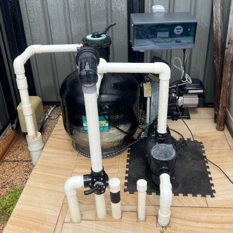 Pool filtration system with black tank, pump, white pipes, and electronic control panel outdoor — Friendly Pool & Spa Care in Coconut Grove, NT 