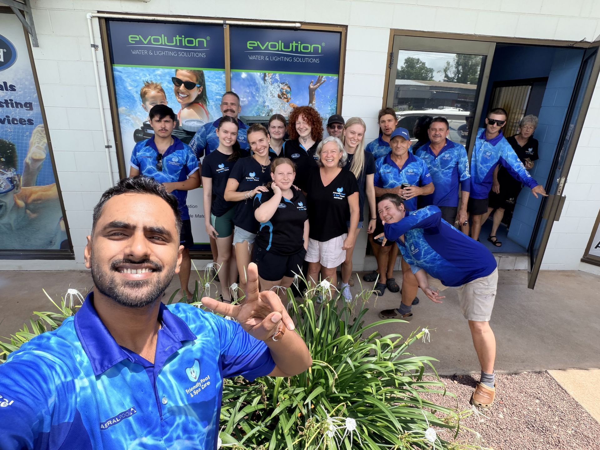 A small rectangular swimming pool with blue water, surrounded by light-colored paving and a white and stone wall  — Friendly Pool & Spa Care in Coconut Grove, NT 