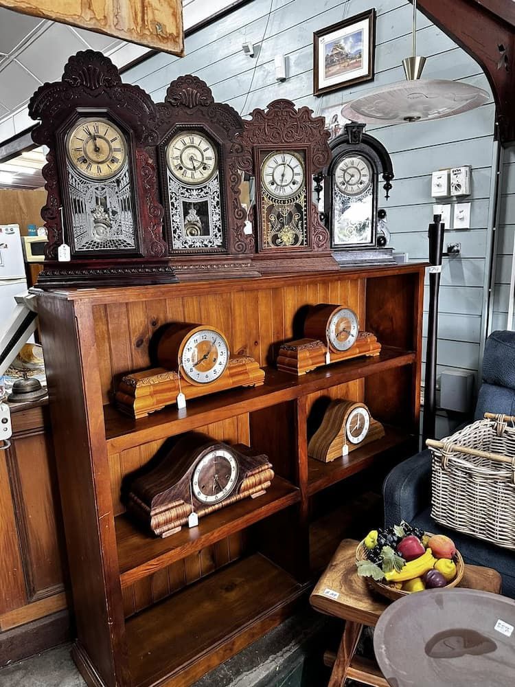 Antique Clocks Displayed on a Wooden Bookshelf — Clancy's Office & Emporium in Taree, NSW