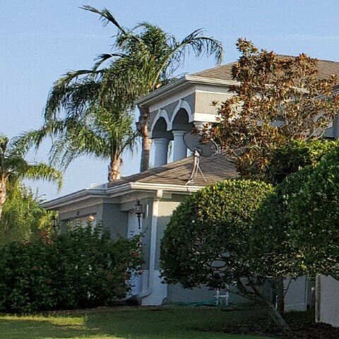 A large house with a satellite dish on the roof