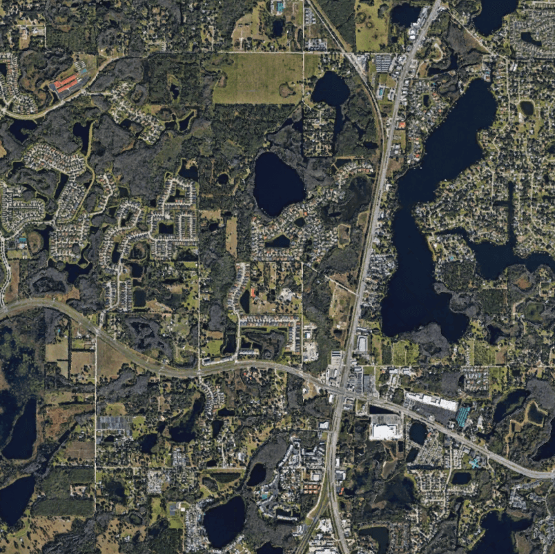 An aerial view of a residential area with lots of lakes