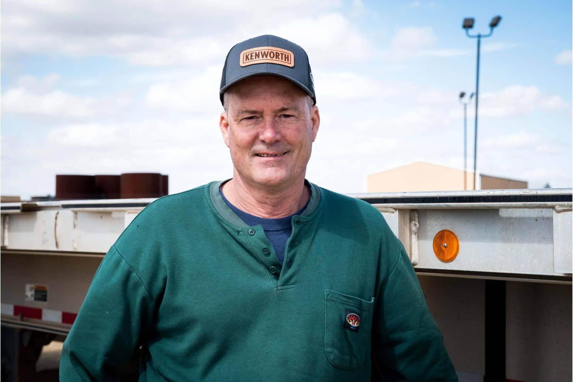 image of male business owner standing in front of trailer