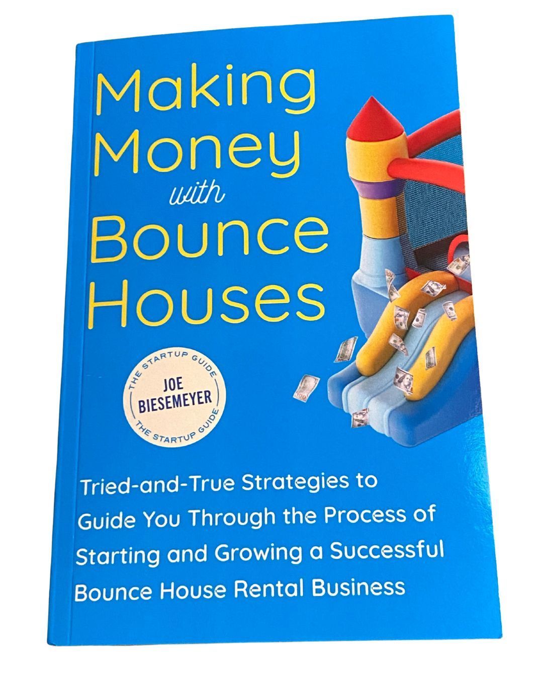 A blue book titled making money with bounce houses