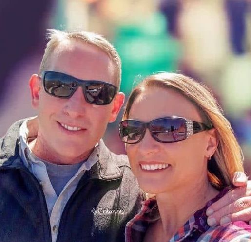 A man and a woman wearing sunglasses are posing for a picture.