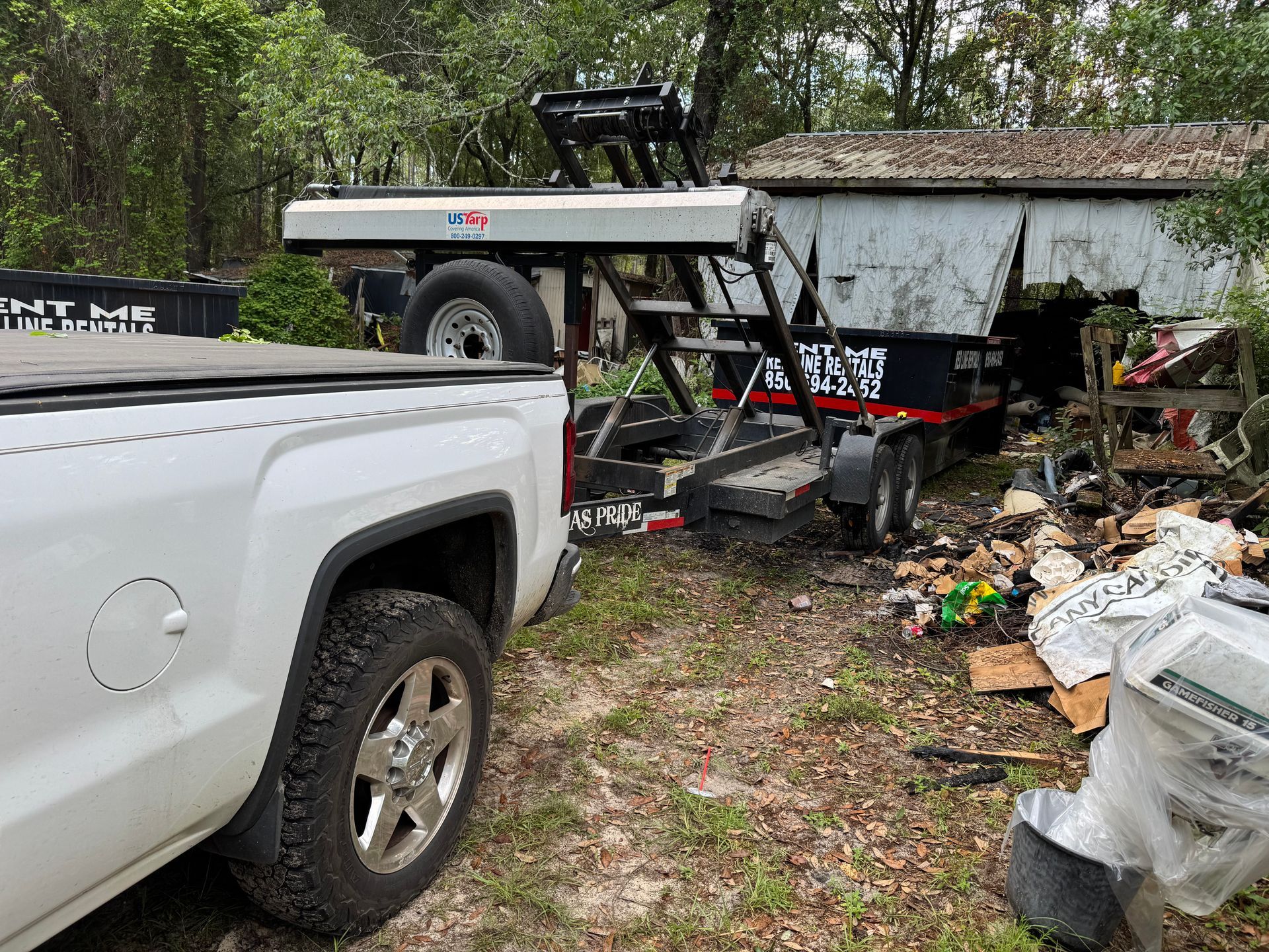 A white truck is towing a boat on a trailer.