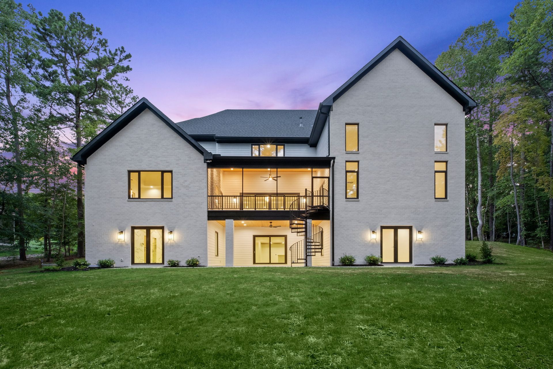 A large house with a lot of windows is covered in snow