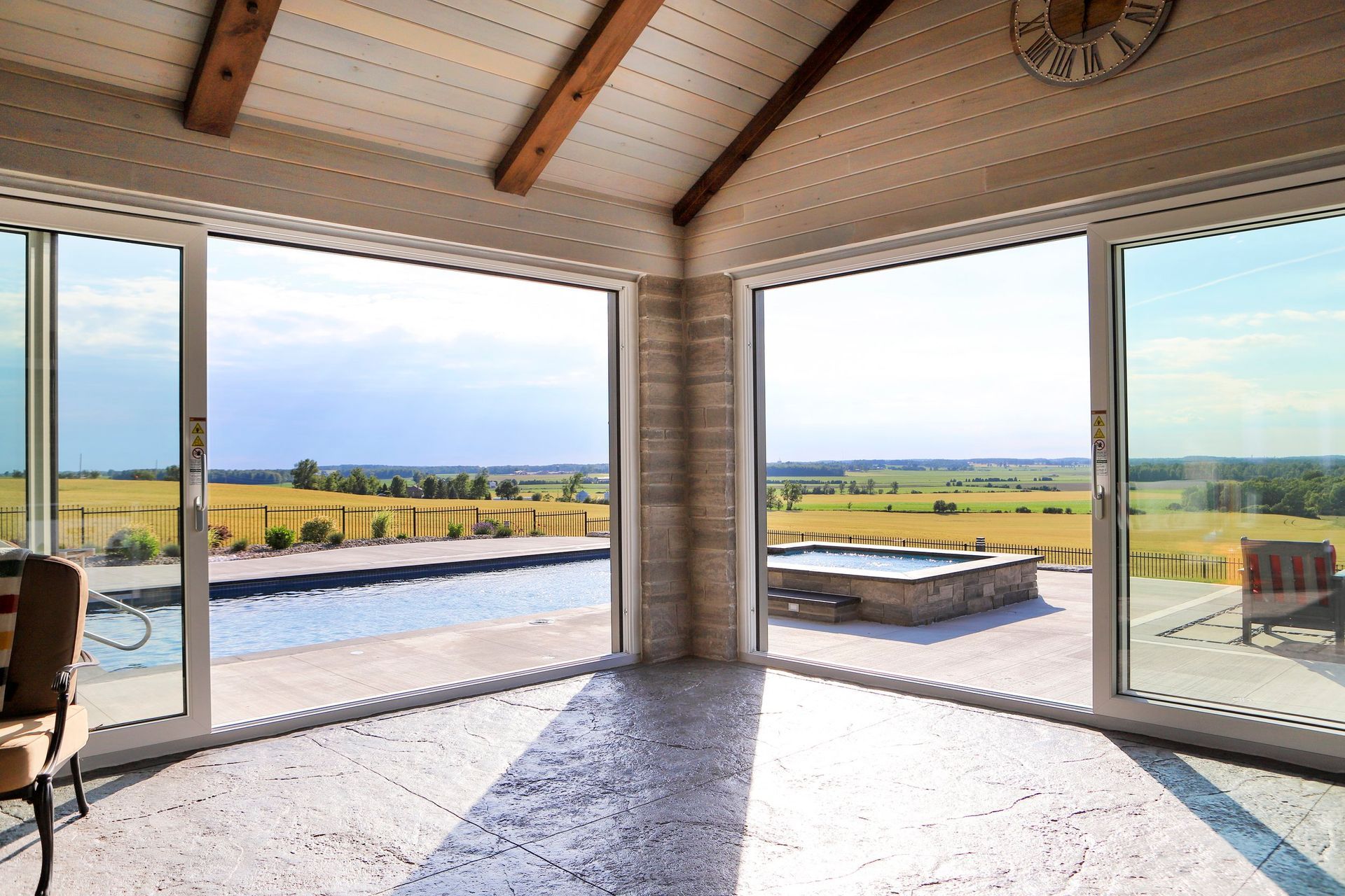 A large room with sliding glass doors leading to a swimming pool