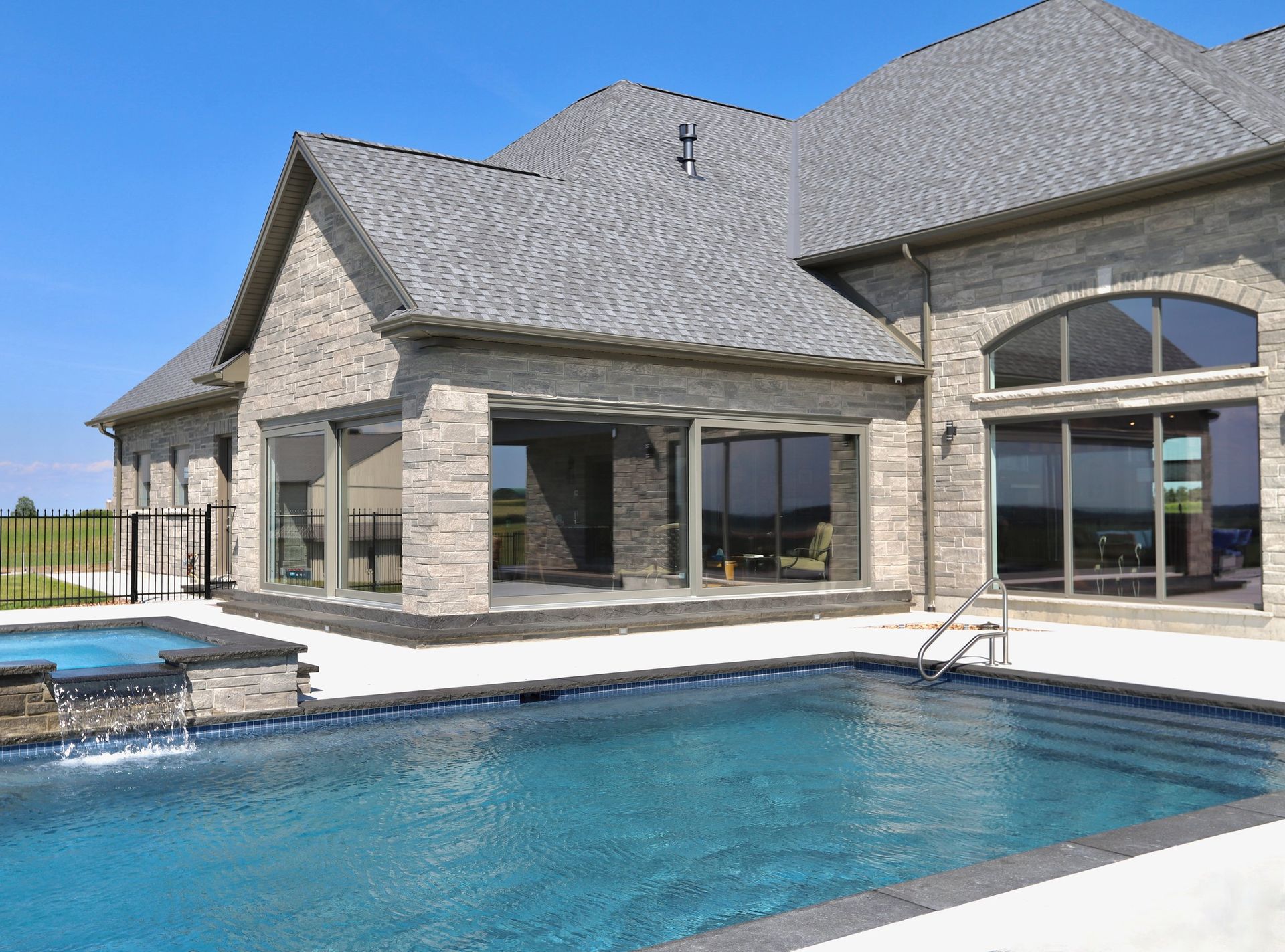 A large house with a large swimming pool in front of it