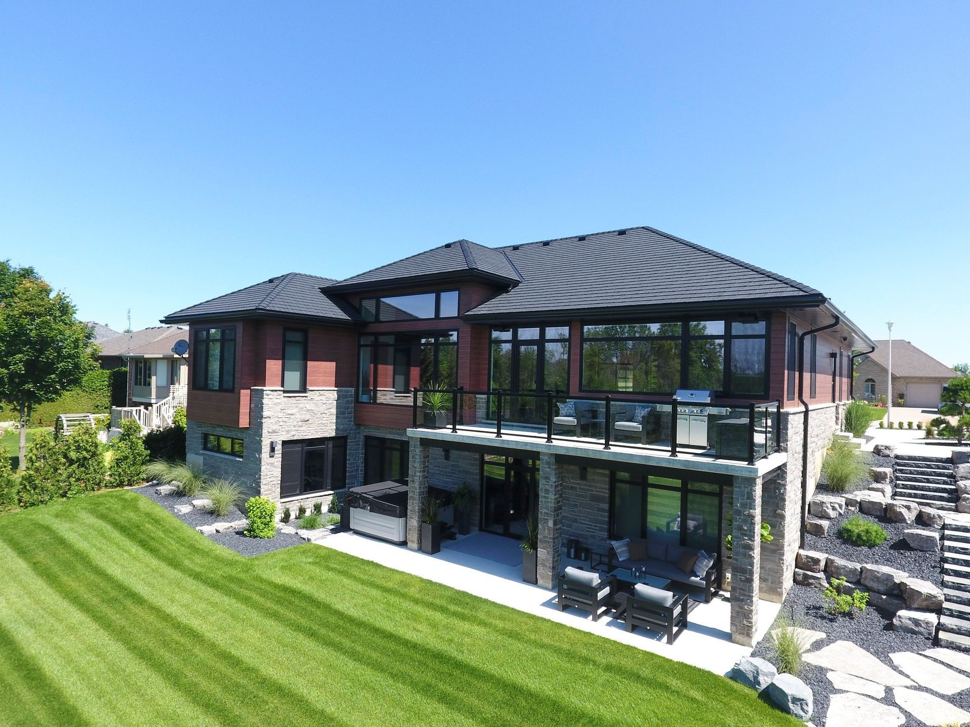 An aerial view of a large house with a large lawn in front of it.