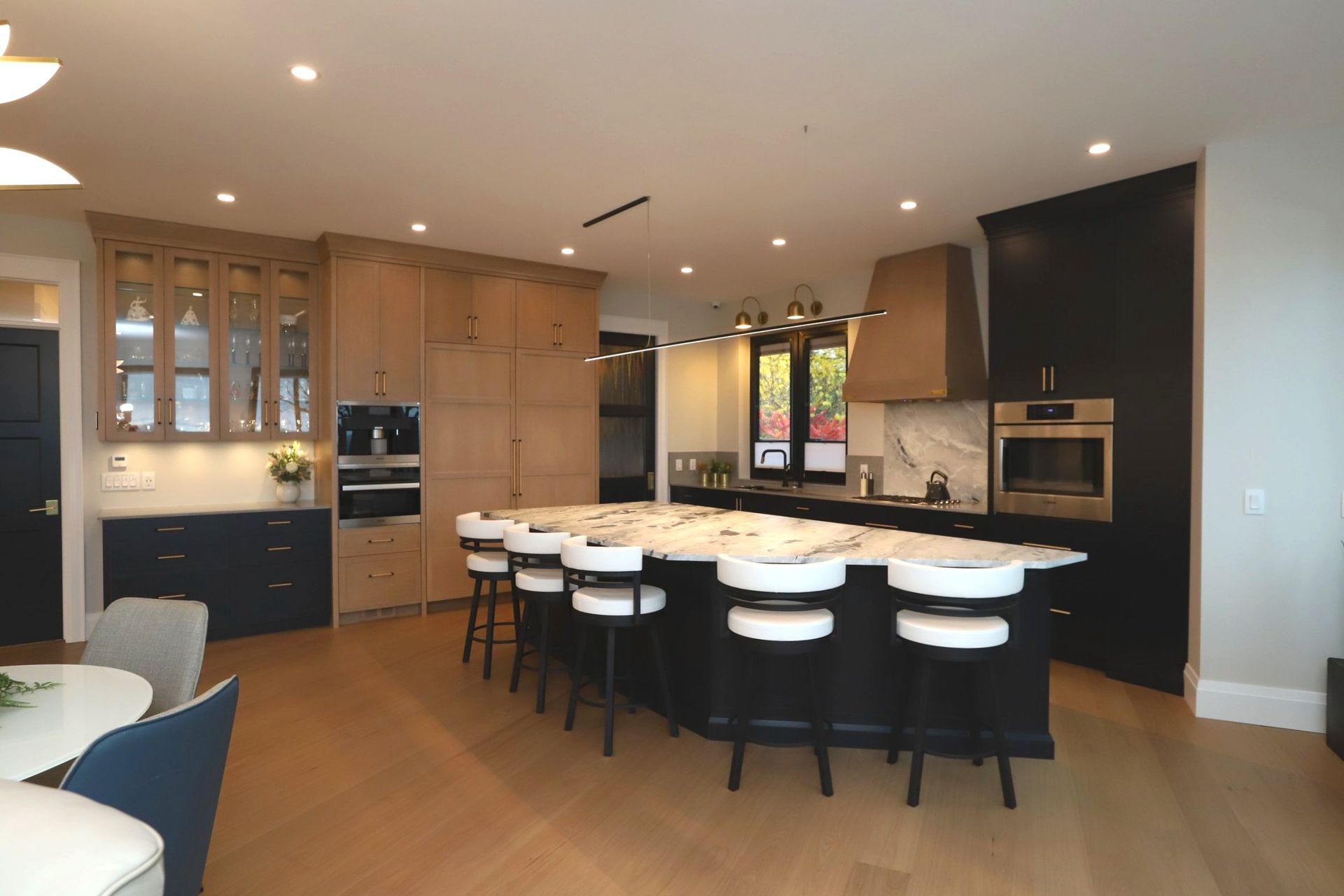 A large kitchen with a large island and stools