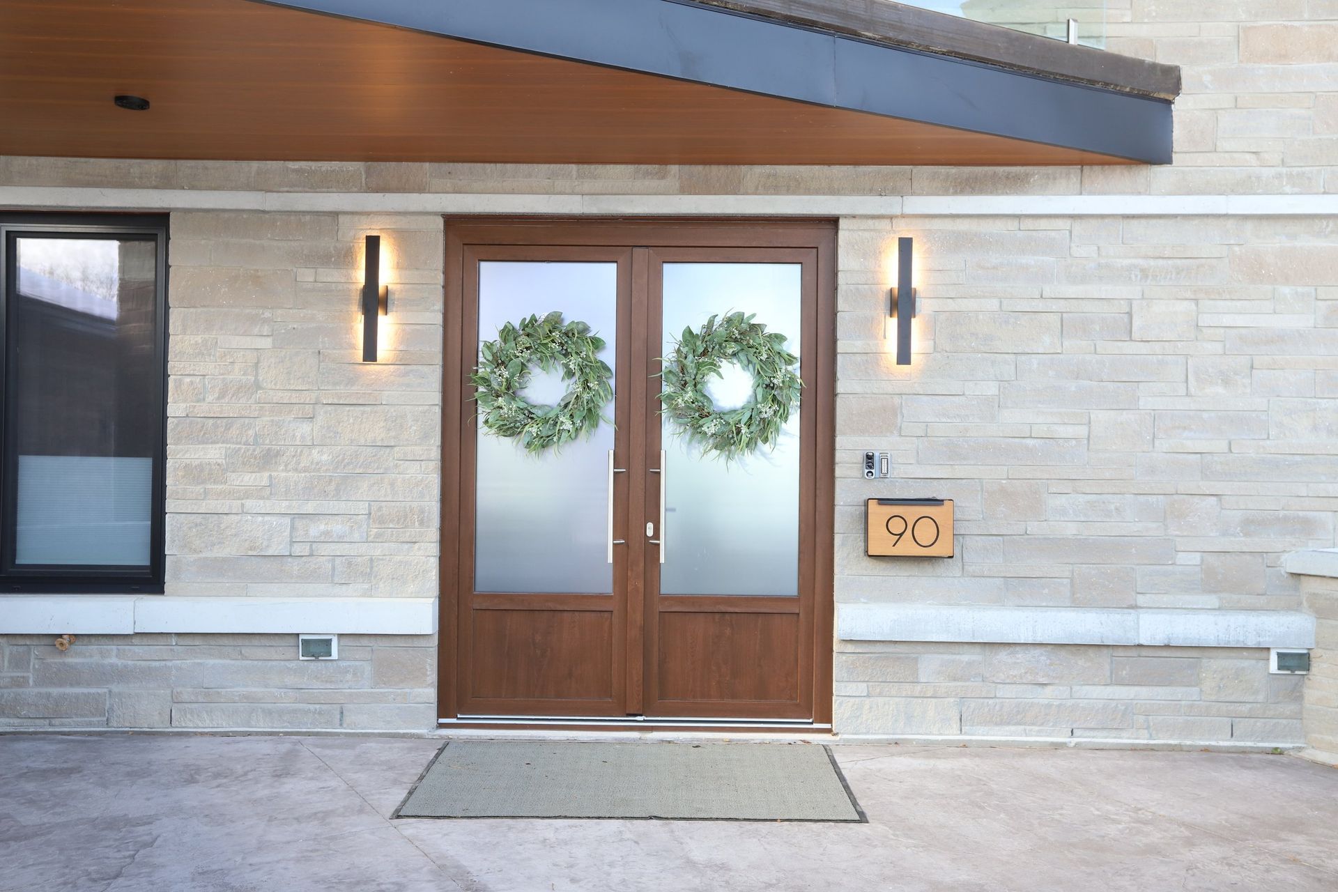The front door of a house with two wreaths on it