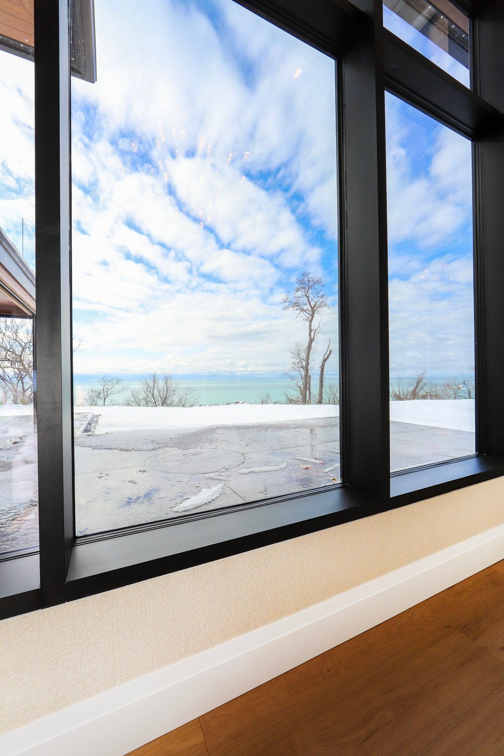 There is a large window with a view of the ocean.