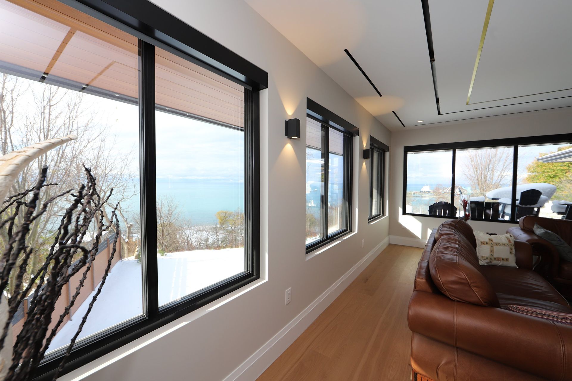 A living room with lots of windows and a couch