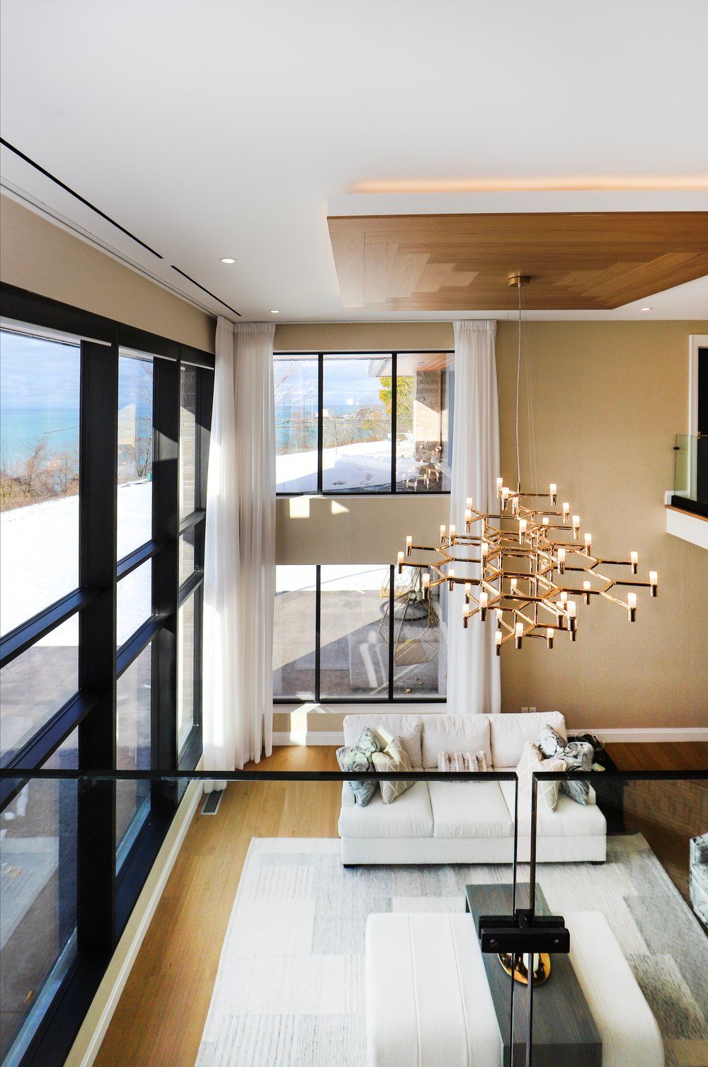 A living room with a white couch and a chandelier