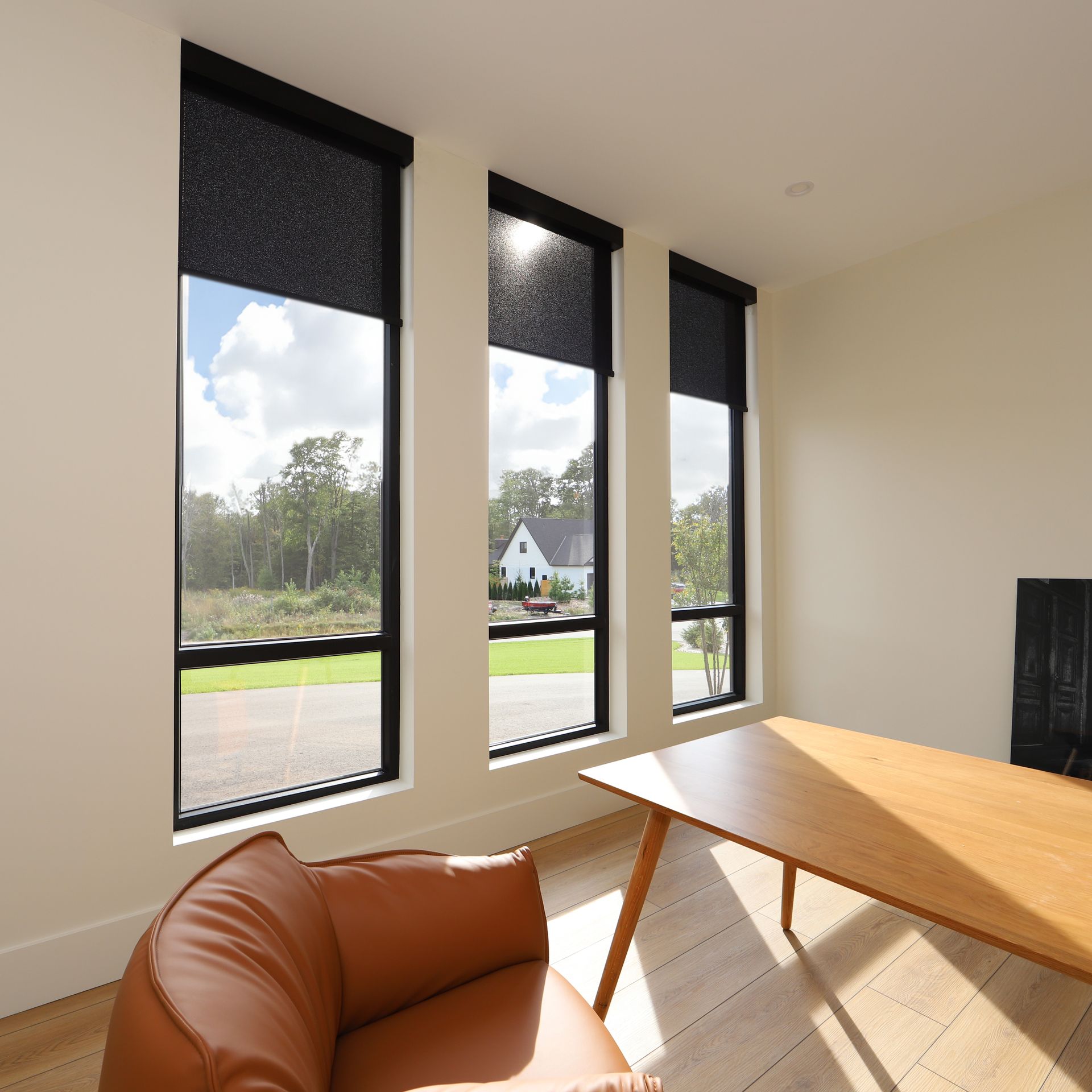 A living room with a brown chair and a wooden table