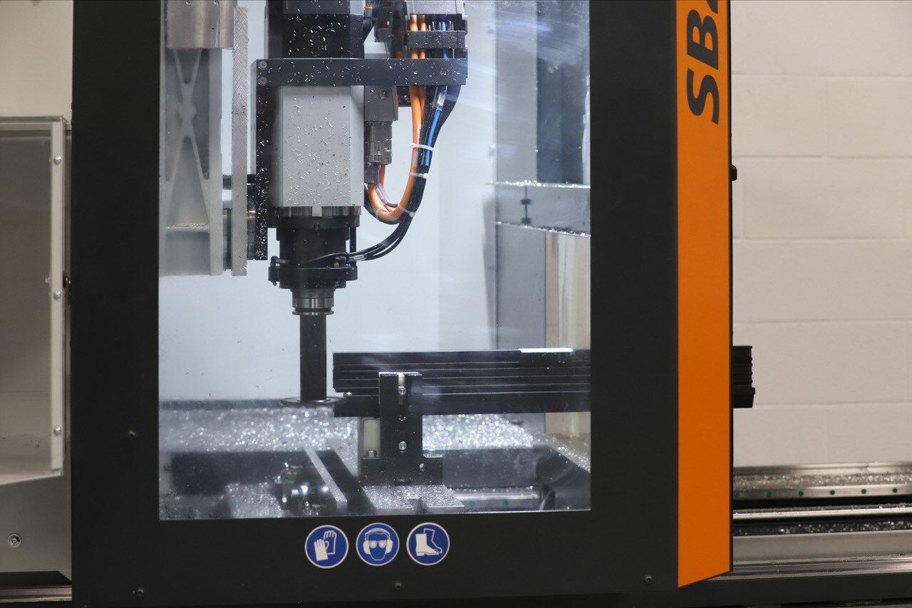 A machine is cutting a piece of metal in a factory.