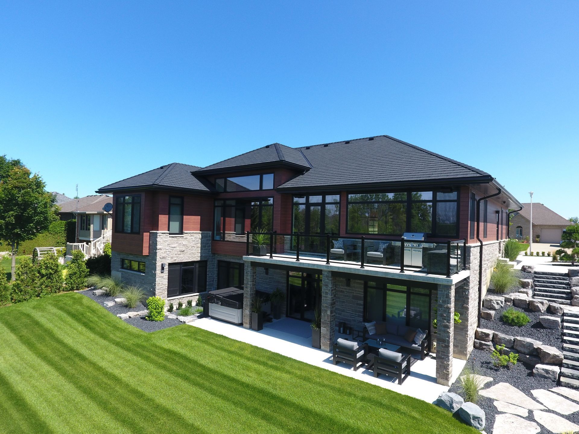 An aerial view of a large house with a large lawn in front of it.