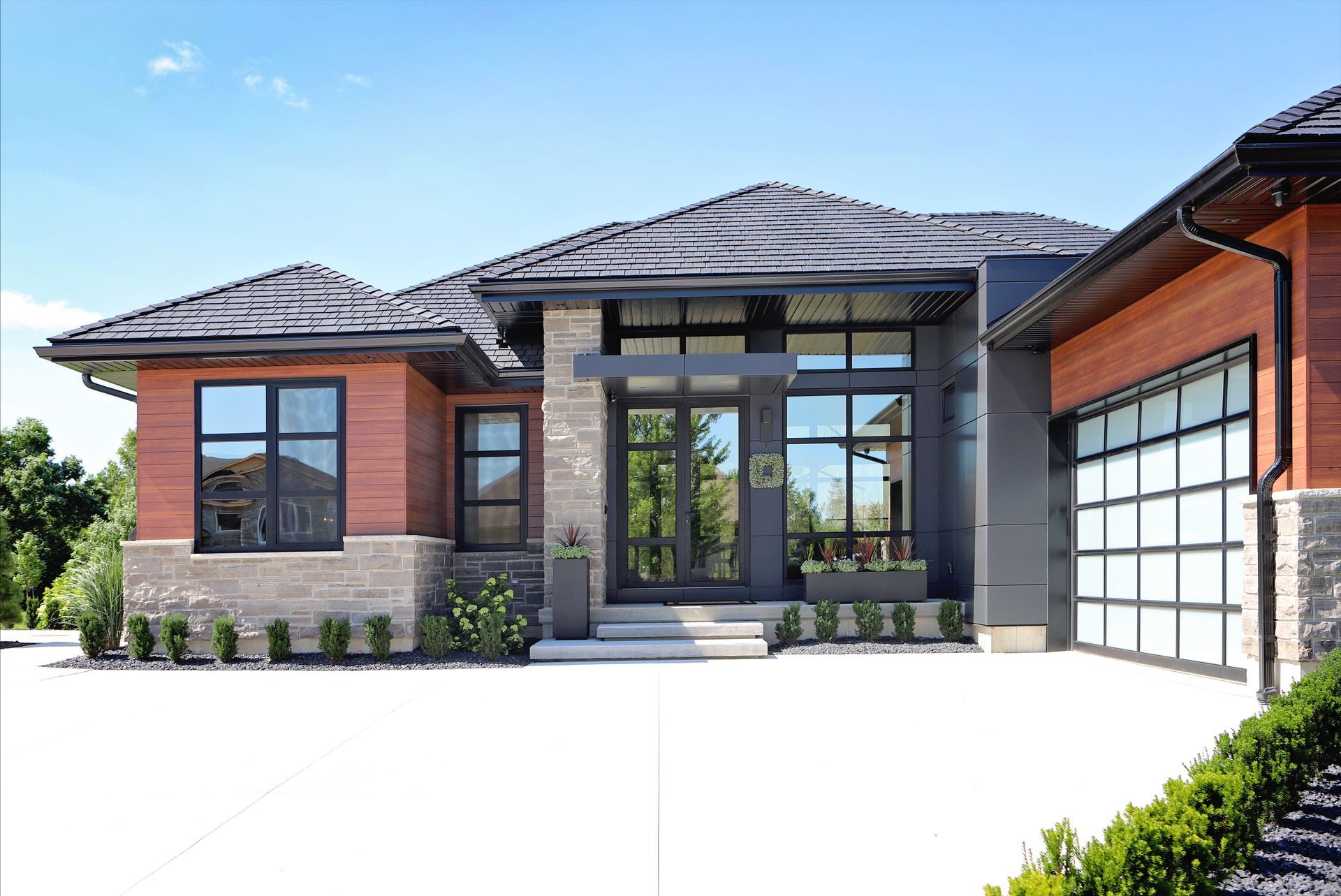 A large house with a garage and a lot of windows