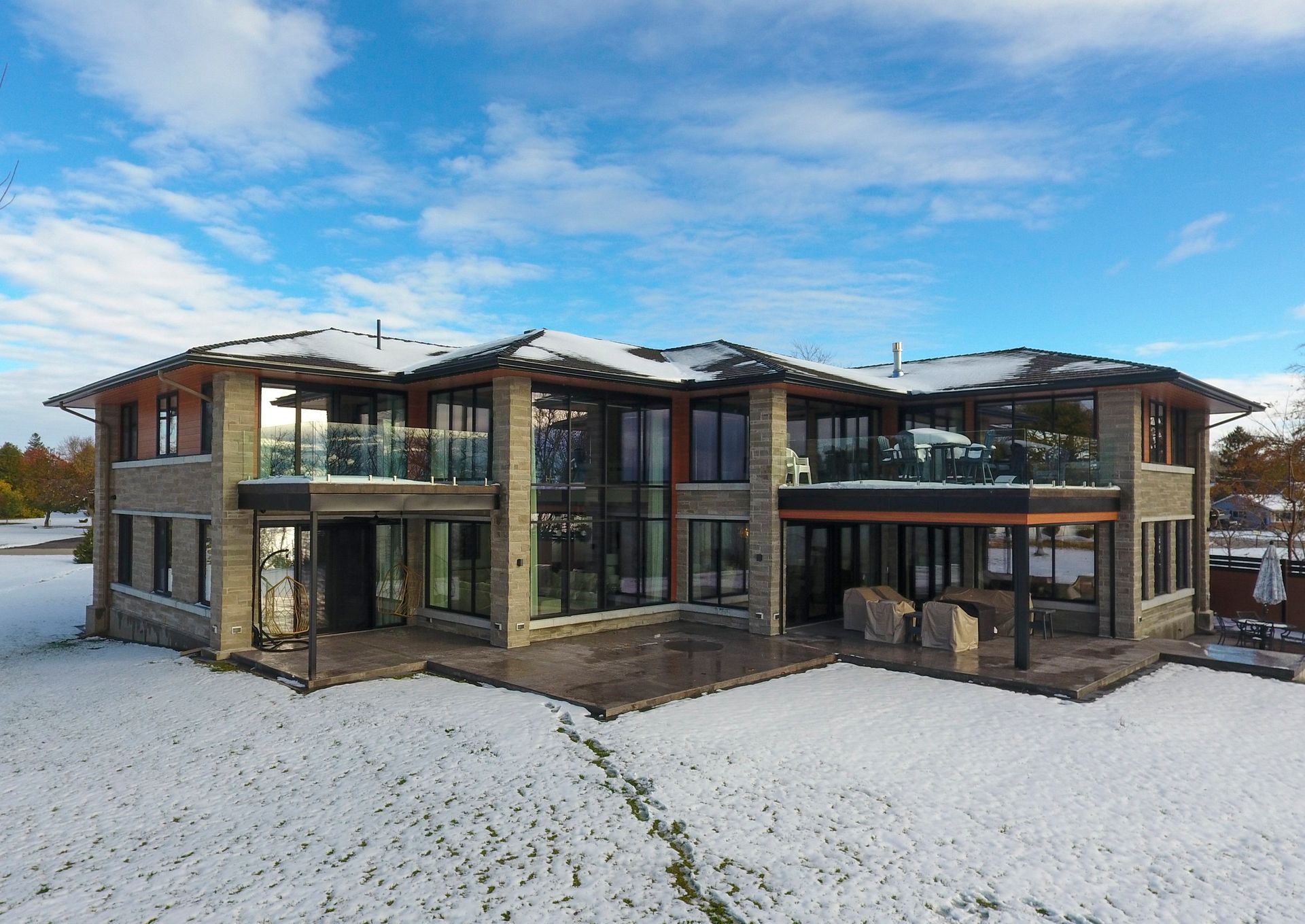 An aerial view of a large house covered in snow.