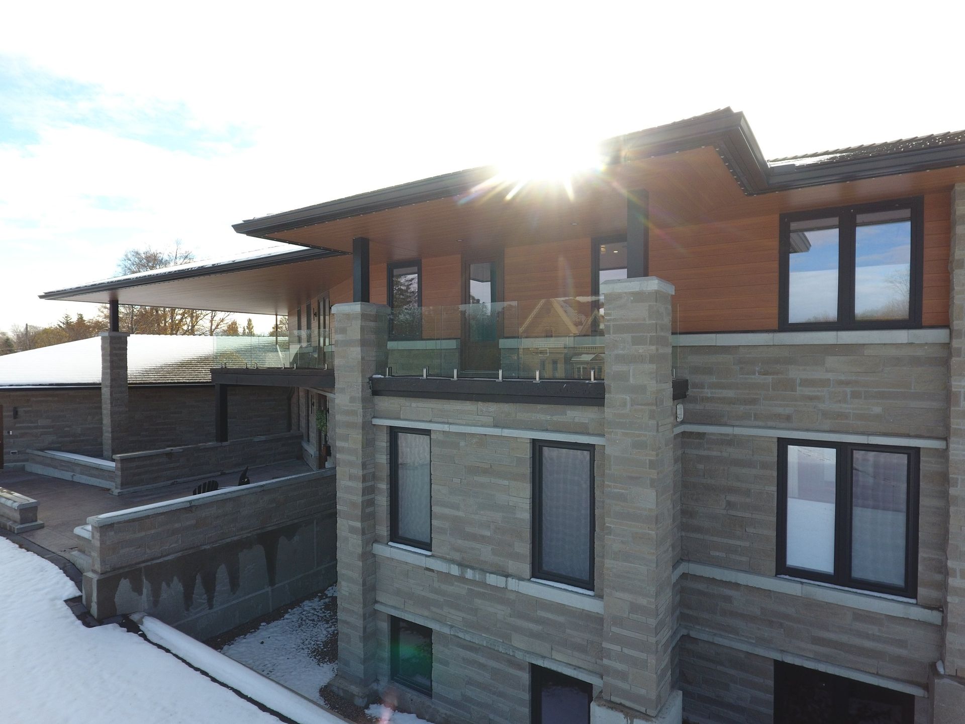 The sun is shining through the windows of a large house.