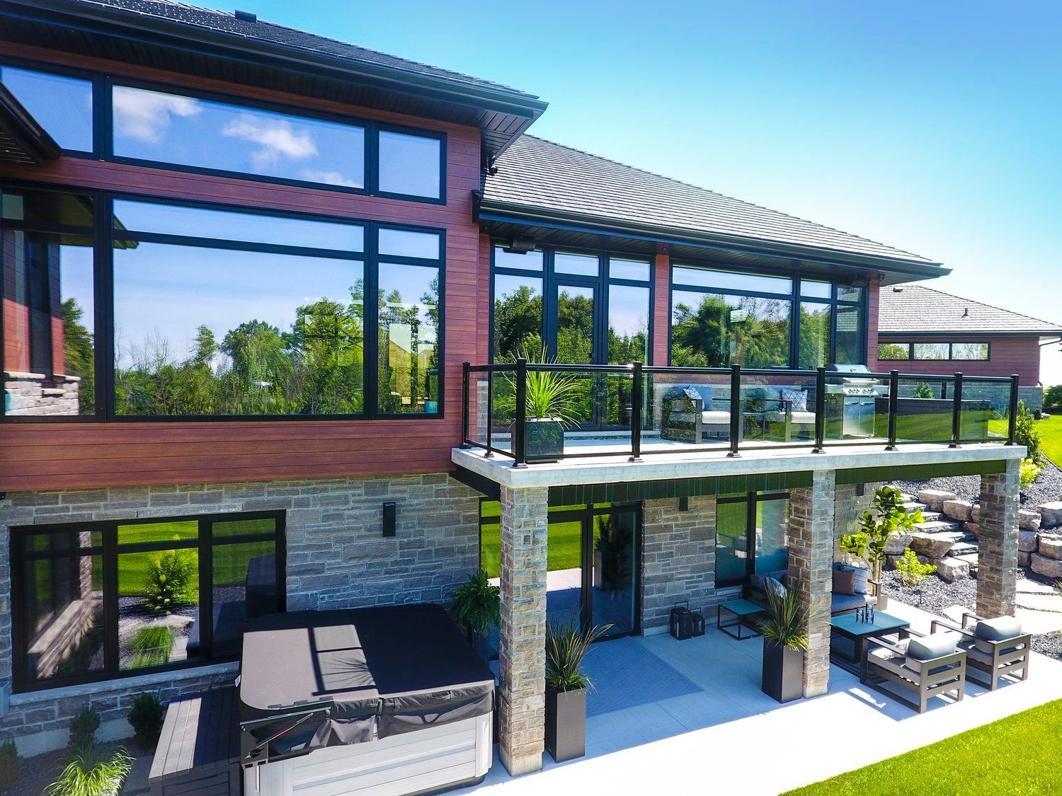 A large house with a large balcony and a hot tub.