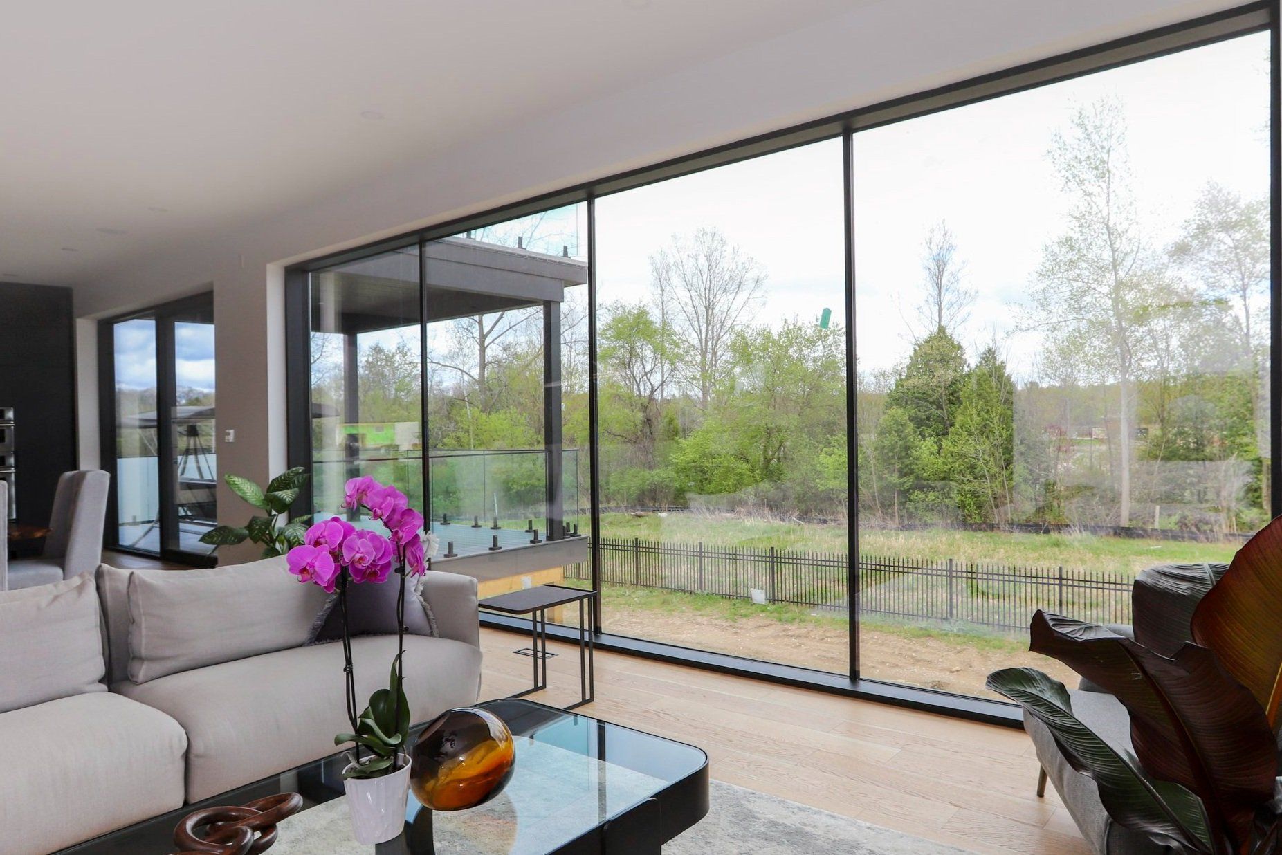 A living room with a lot of windows and a couch.