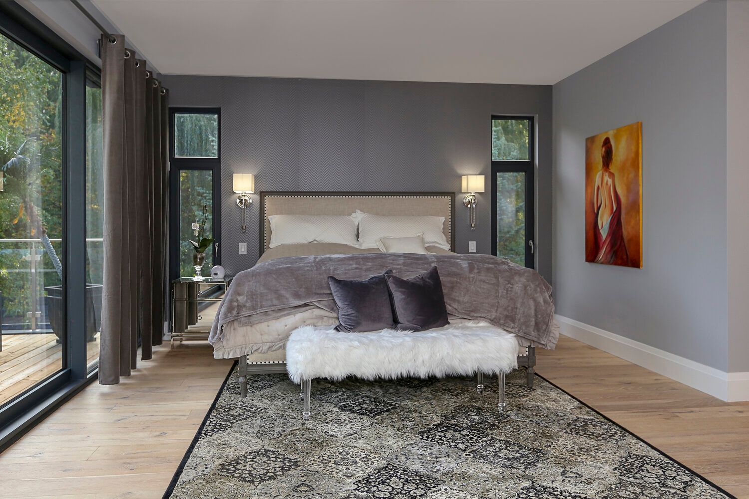 A bedroom with a large bed and a bench