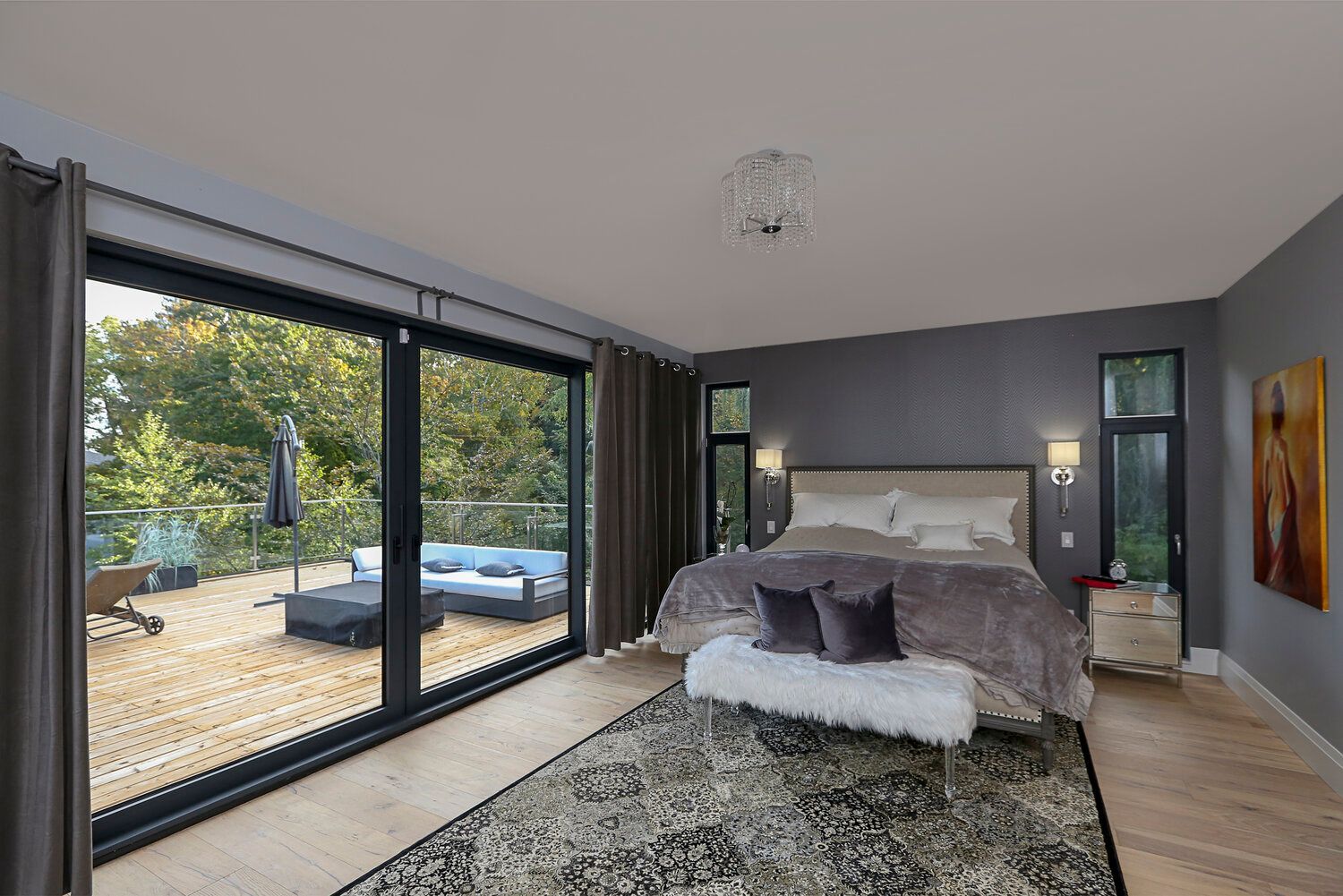 A bedroom with a large bed and lots of windows