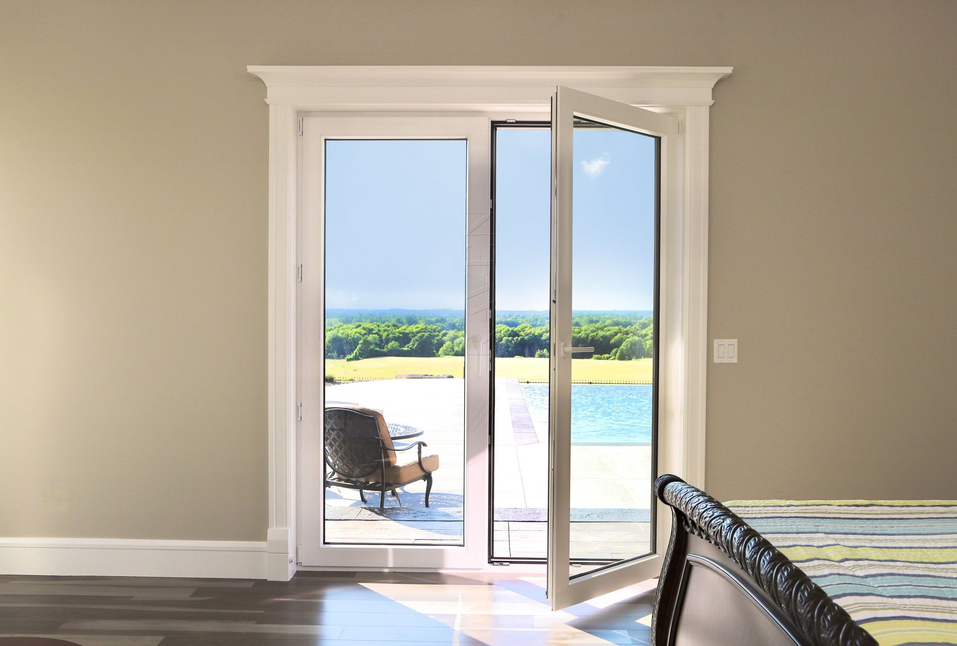 A bedroom with a sliding glass door leading to a patio.
