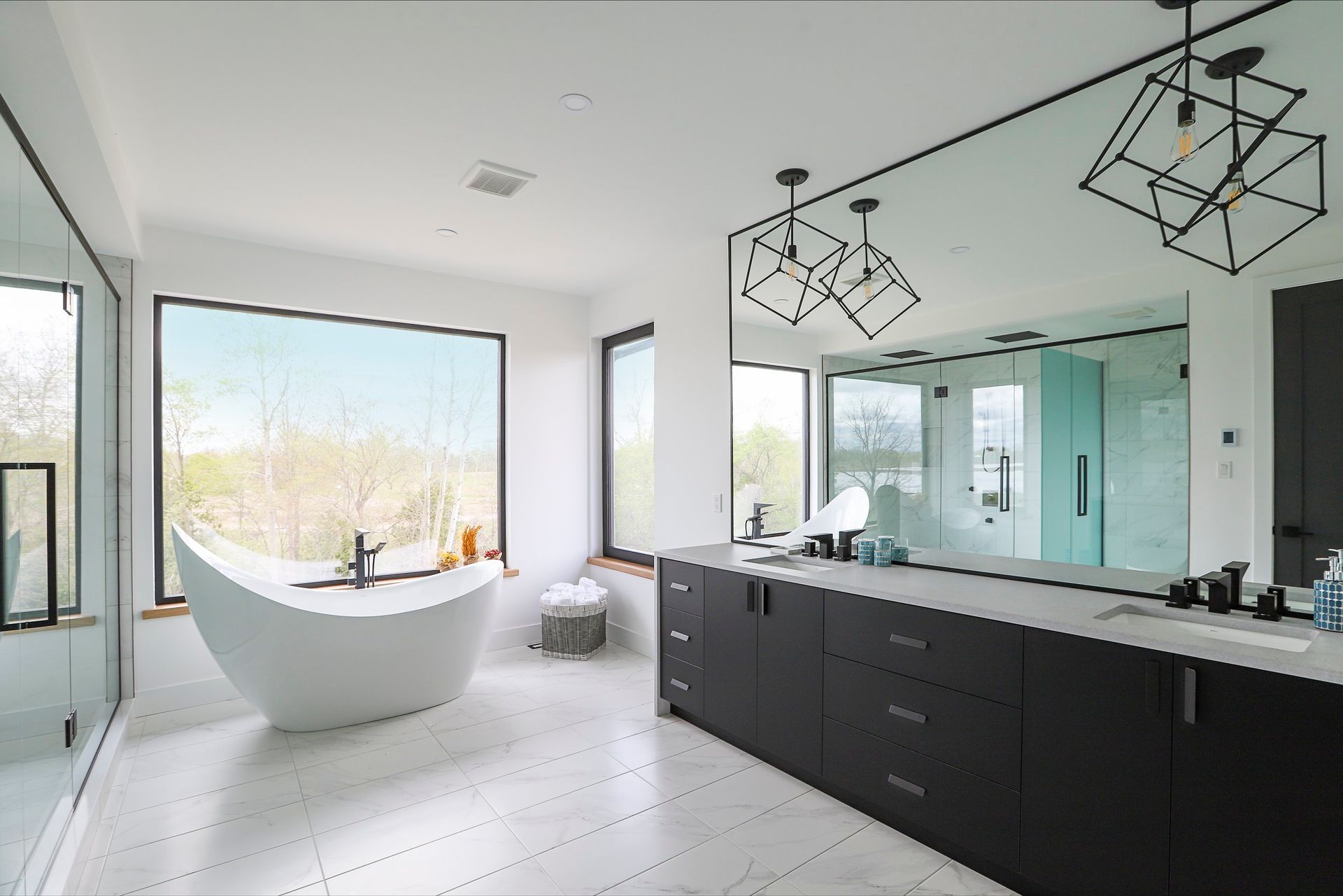 A bathroom with a bathtub and a large mirror.