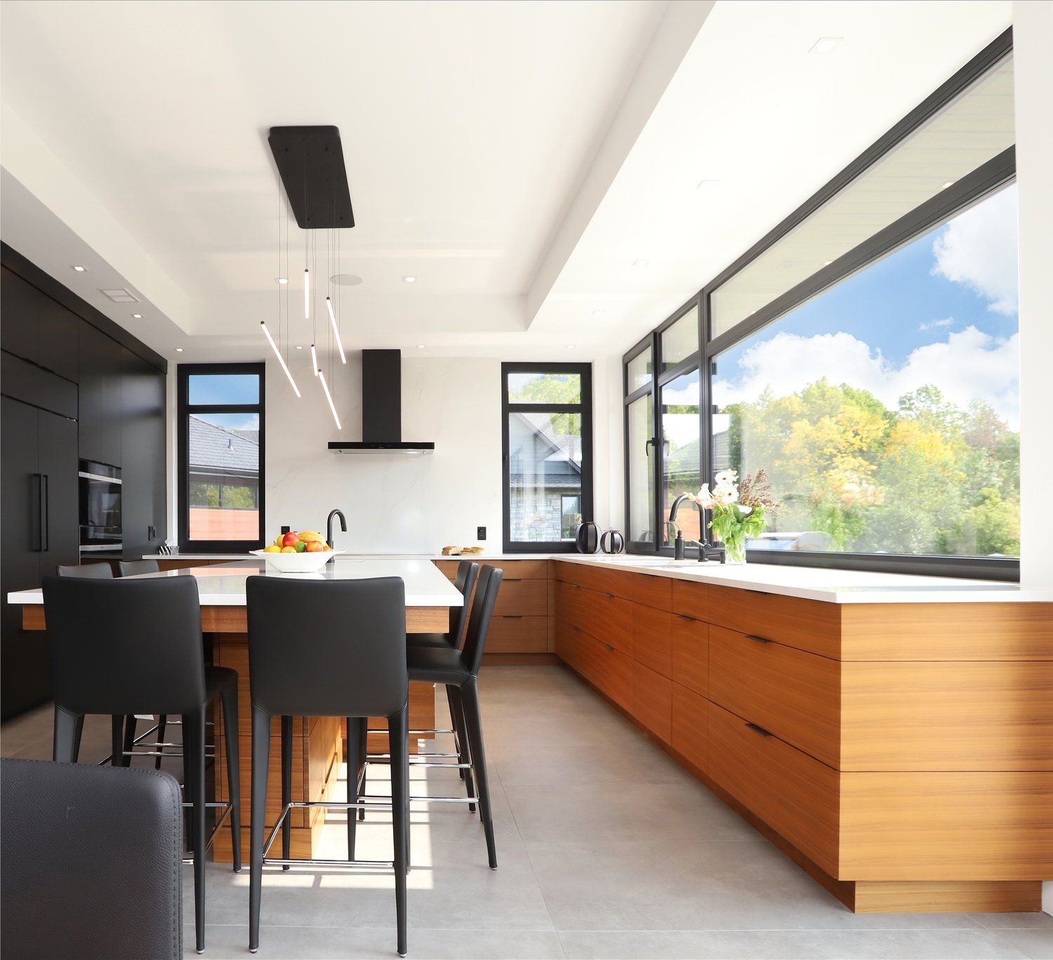 A kitchen with a large island and lots of windows