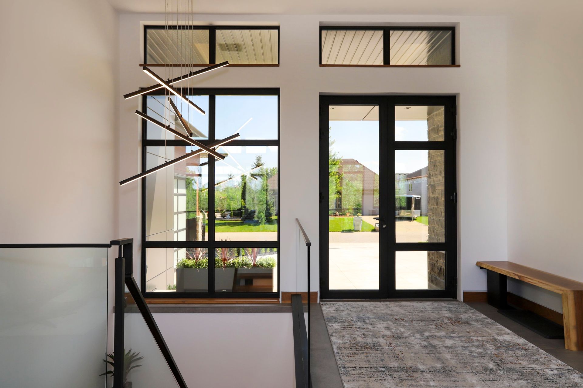A hallway with a staircase leading up to the second floor of a house.