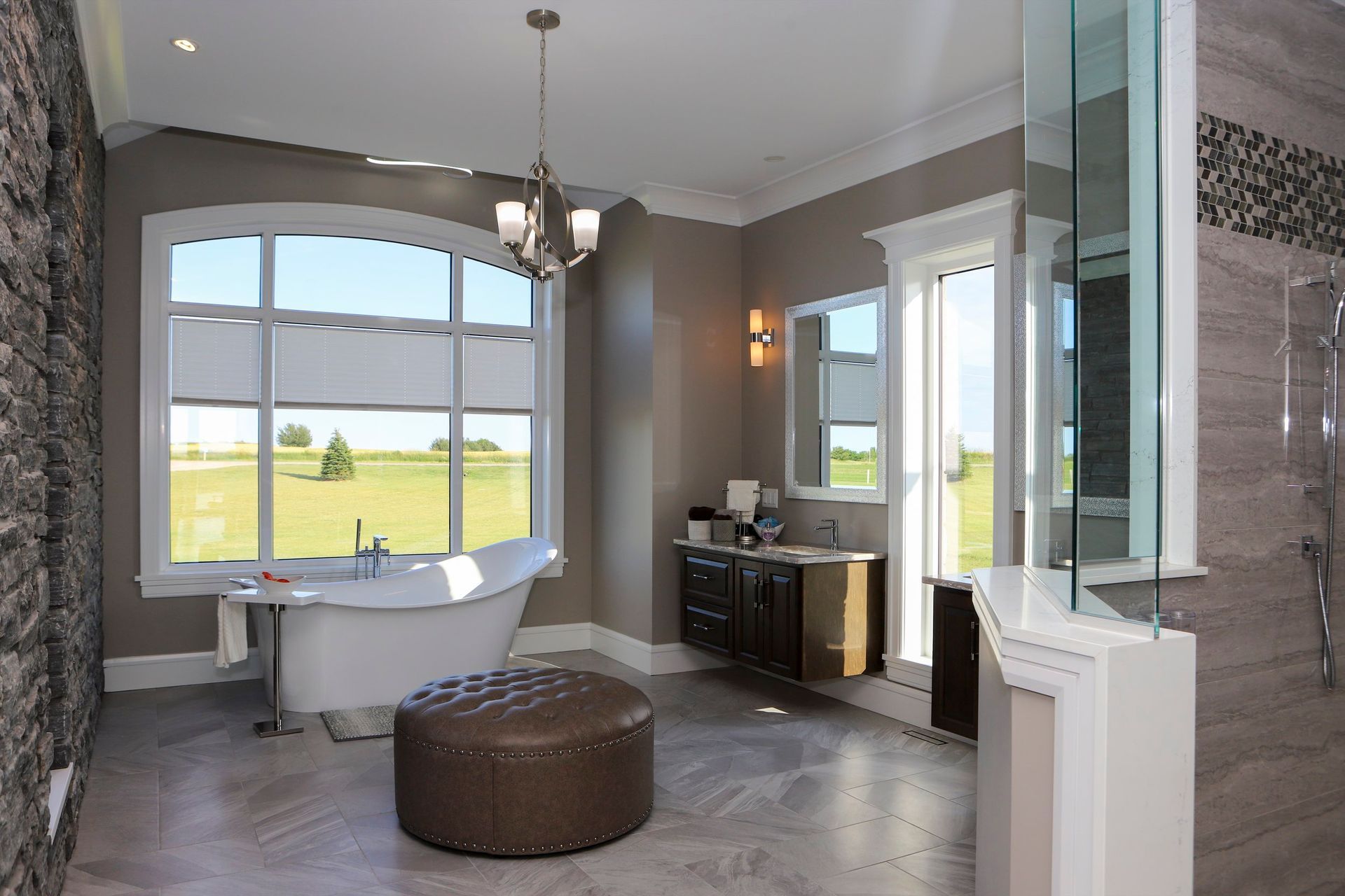 A bathroom with a tub , sink , and window