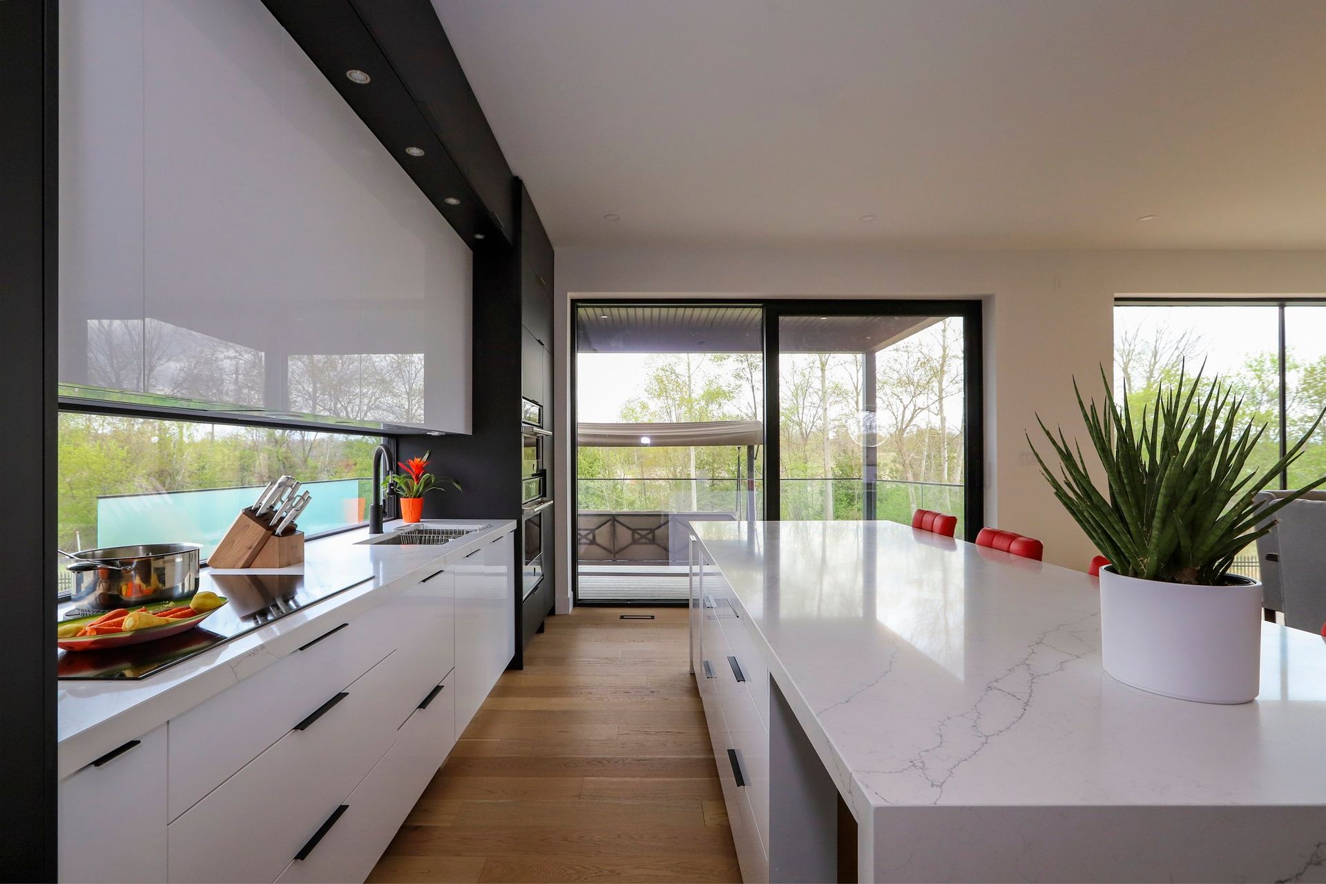 A kitchen with white cabinets and a large island.