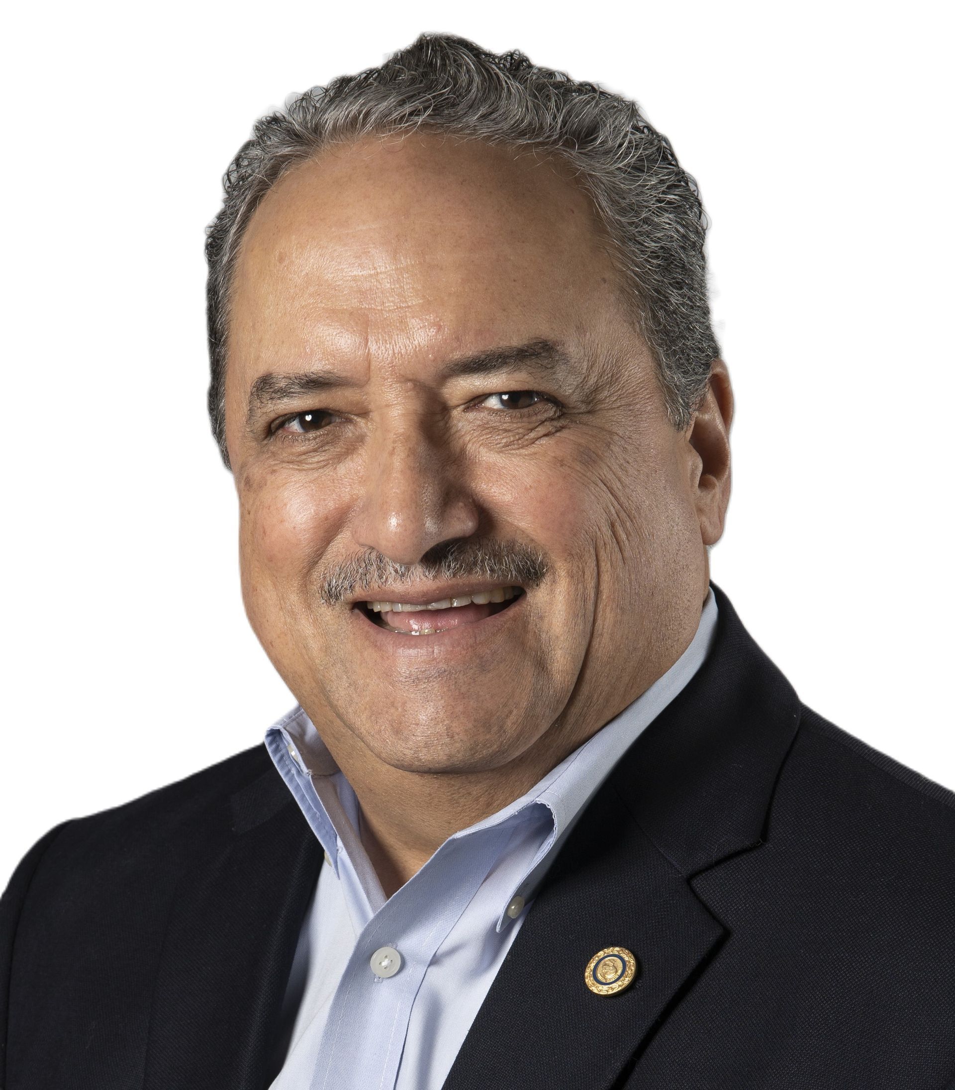 A man in a suit and tie is smiling for the camera.