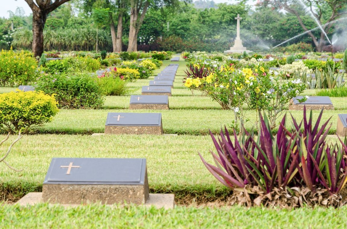 A cemetery filled with lots of graves and plants.