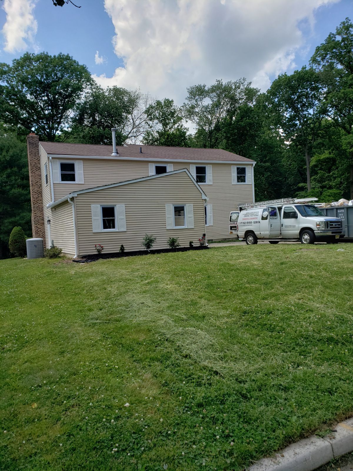 A living room with two couches , a fireplace and a flat screen tv.