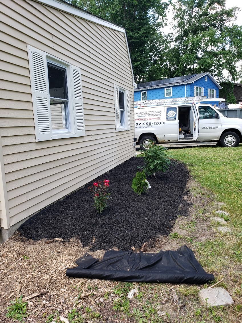 A kitchen with wooden cabinets , a stove , a sink , and a window.