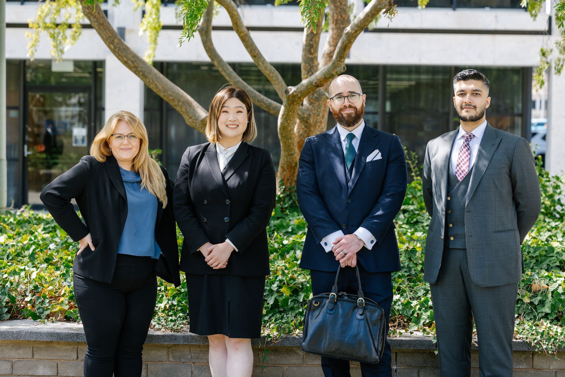 The Andrew Byrnes Law Group in suits and ties, standing side by side