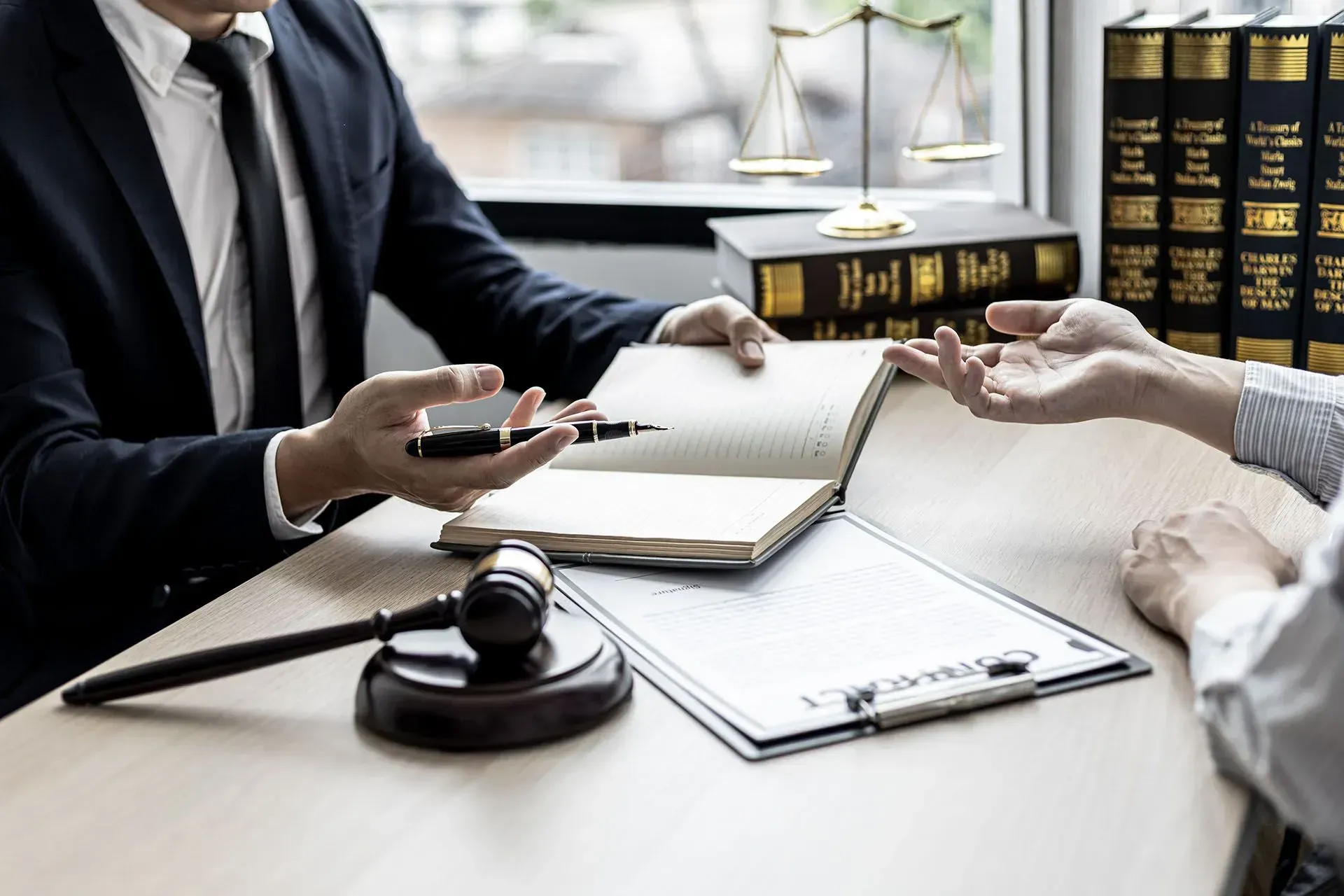 A lawyer is sitting at a table talking to a client.