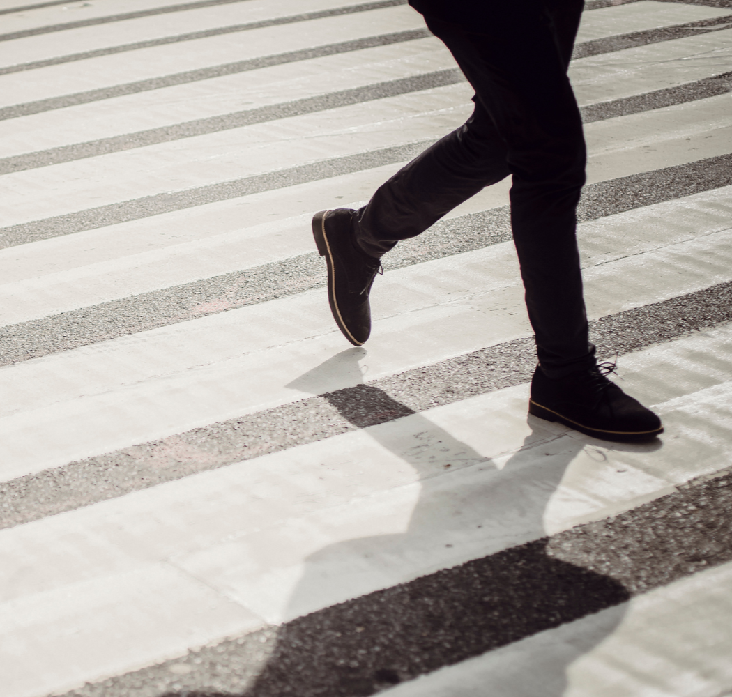 Man in hospital bed smiles at woman, who touches his shoulder.