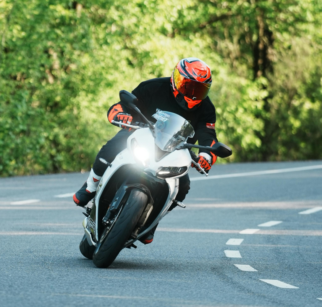 Man in hospital bed smiles at woman, who touches his shoulder.