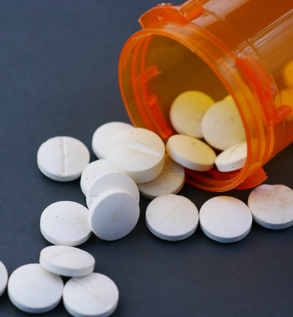 Father and child embrace in a car. The father smiles, wearing a striped shirt.