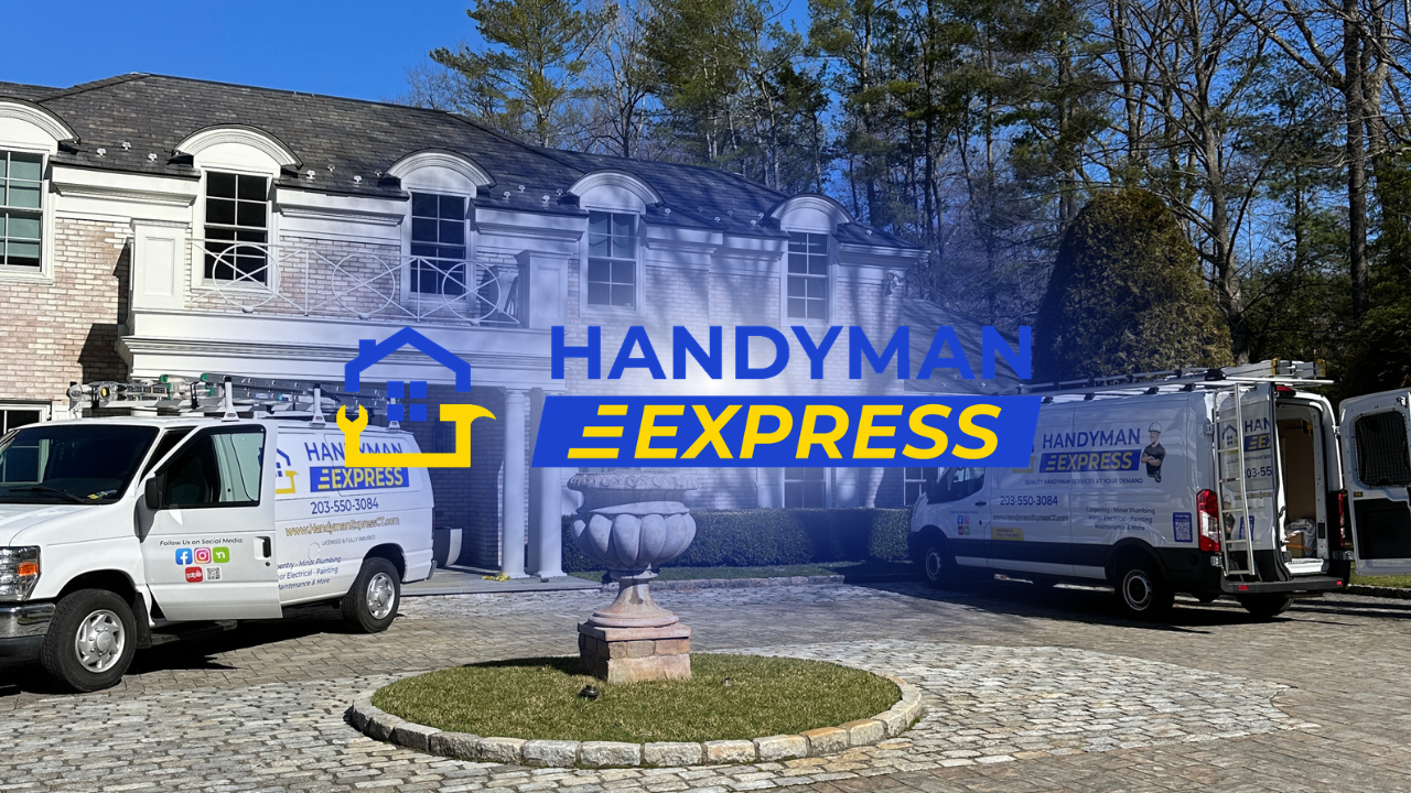 Handyman Express trucks parked outside a stone building in a sunny driveway.